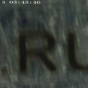 Видео гравированного текста на серебре высотой 1 мм под микроскопом